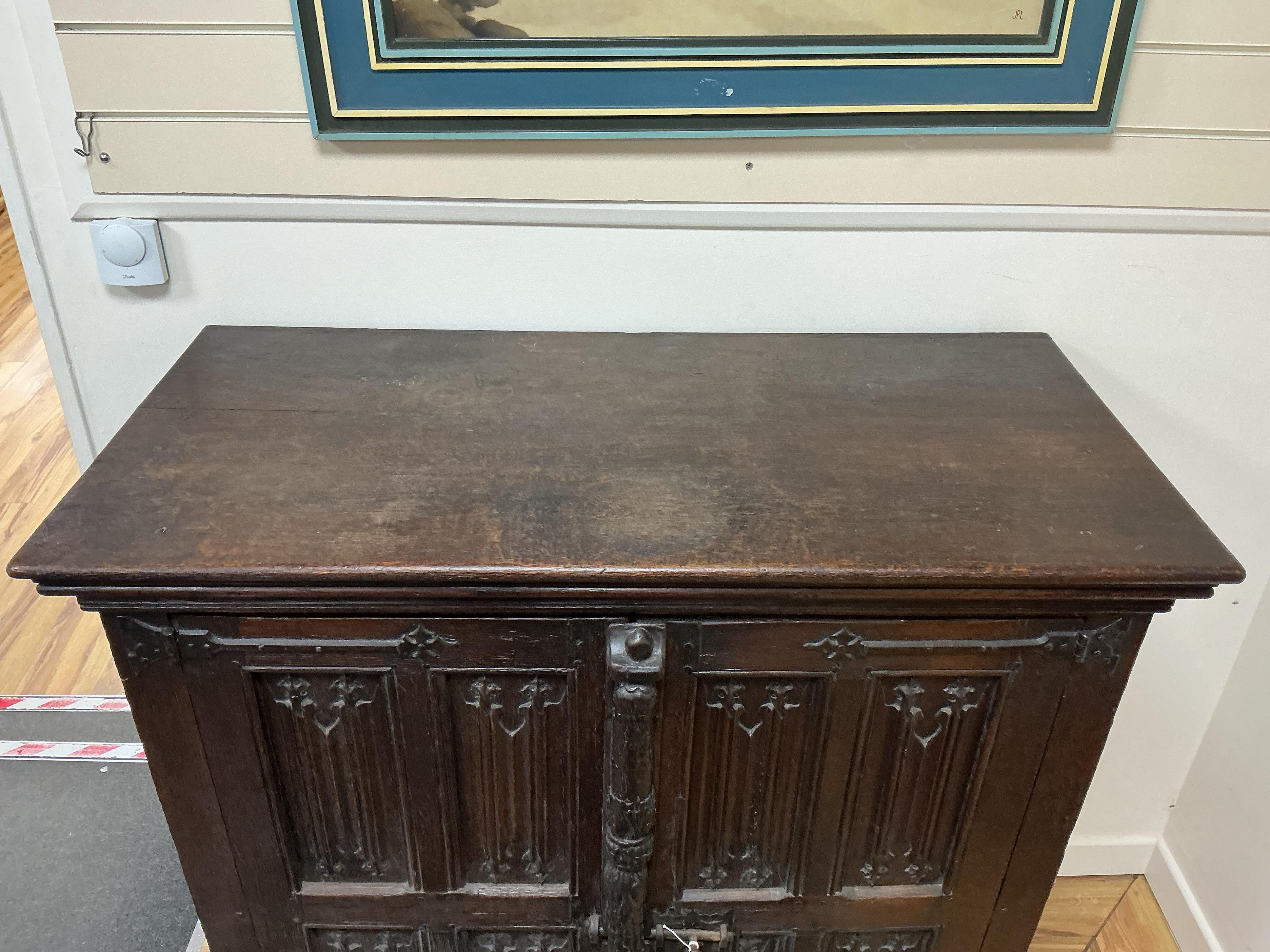 An 18th century and later French carved oak two door cabinet, width 115cm, depth 53cm, height 115cm